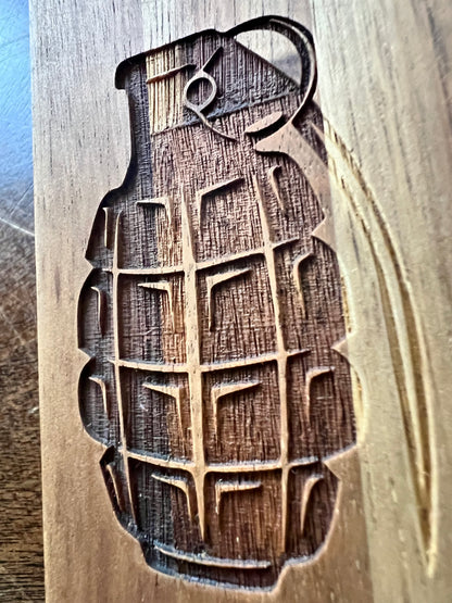 Grenade laser engraved on wood with deep dimensional detail