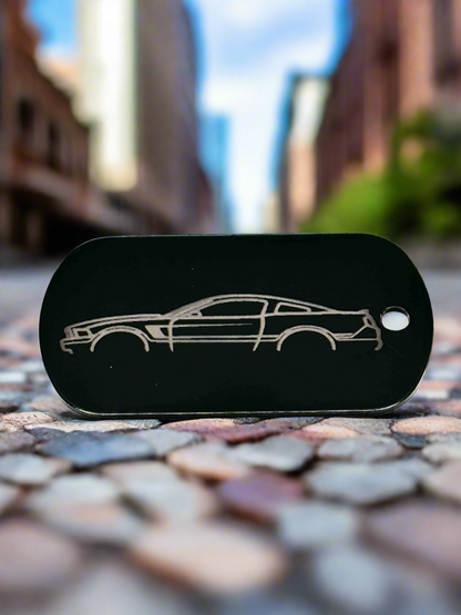 Black dog tag engraved with a sports car silhouette