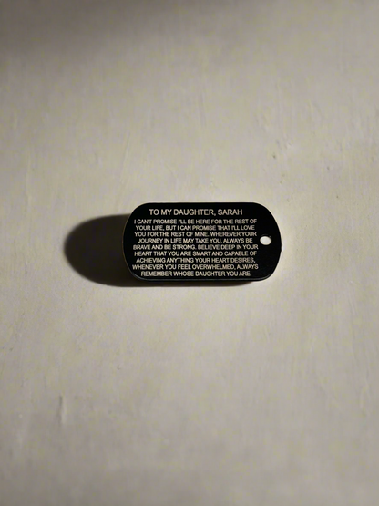 Dog tag with engraved message text on the back