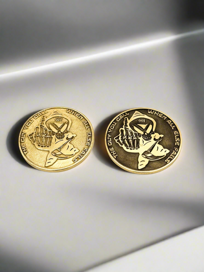 Two brass challenge coins engraved with unit insignia