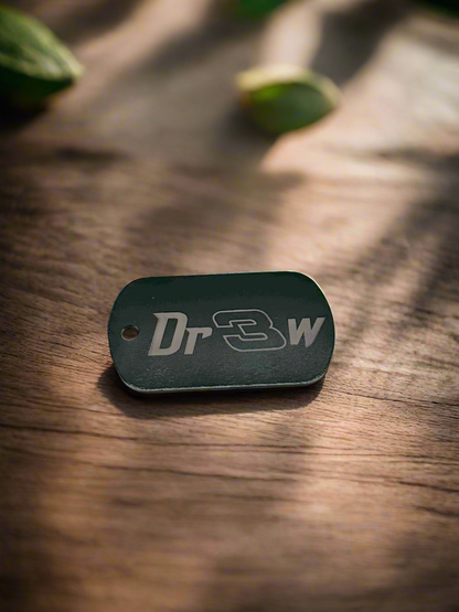 Black anodized dog tag engraved with a name