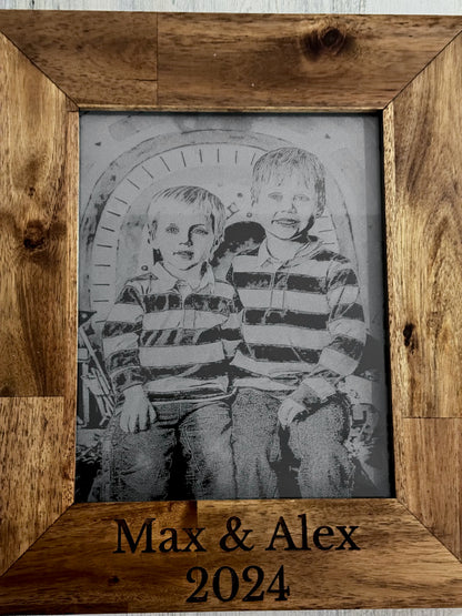 Two children engraved on slate with Max & Alex 2024 in a wood frame