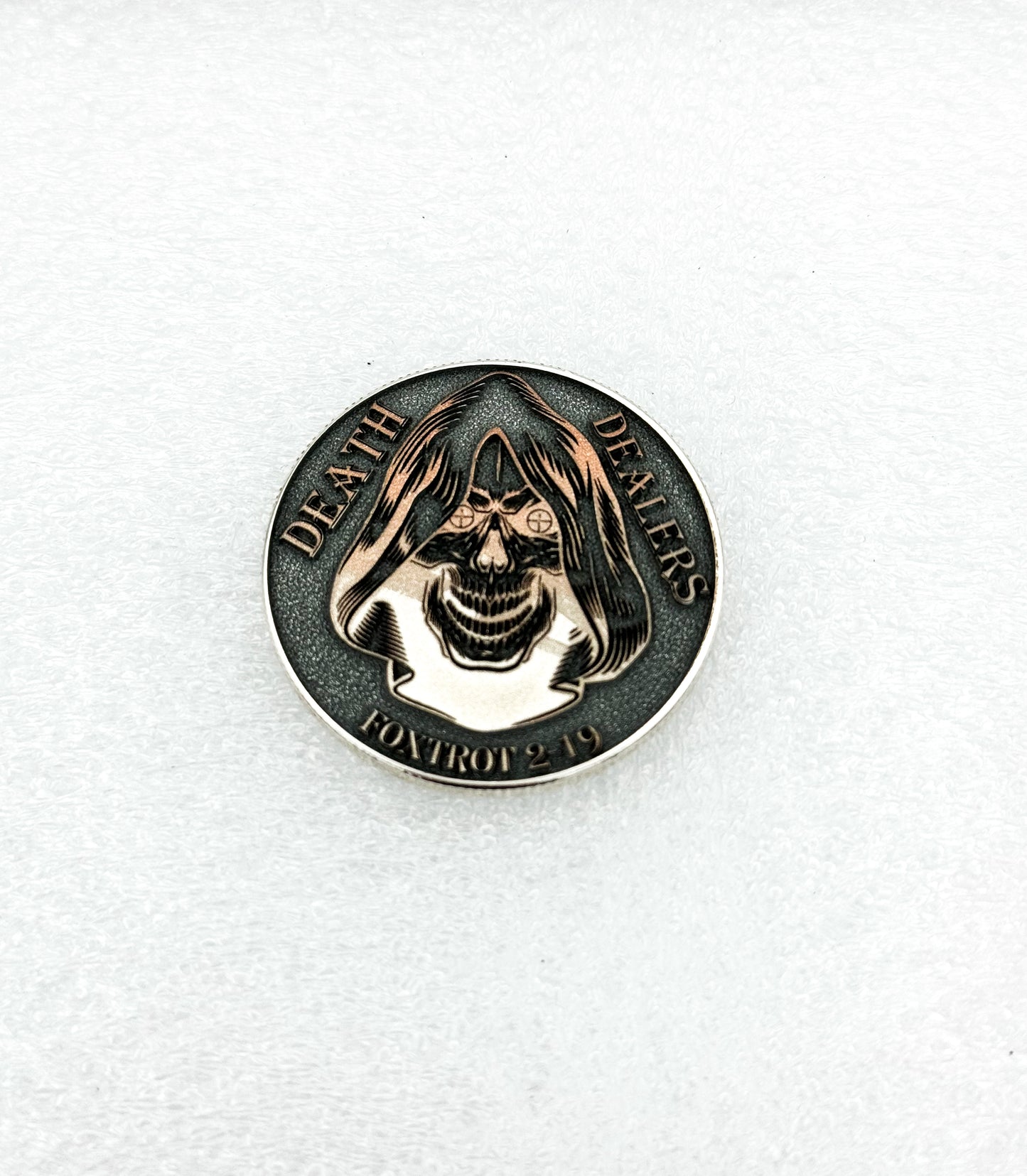 Dark antiqued challenge coin with engraved detail