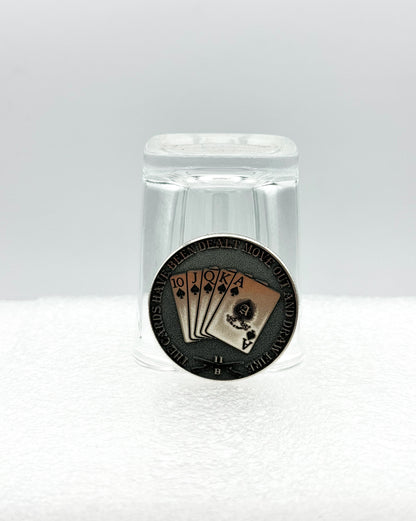 Engraved coin displayed with a shot glass