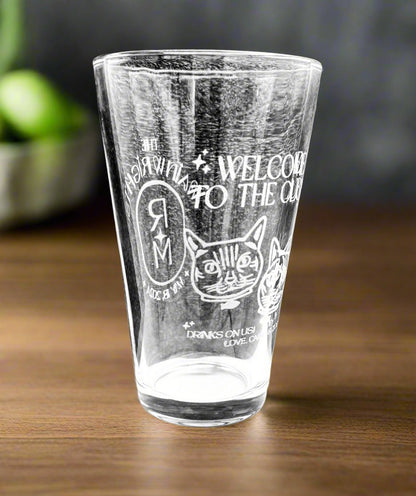 Pint glass etched with a business logo and lettering