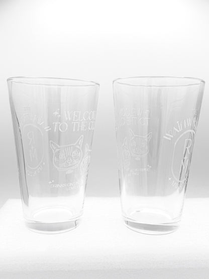 Two engraved pint glasses side by side on a white background