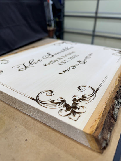 Engraved basswood plaque with decorative scrollwork corners