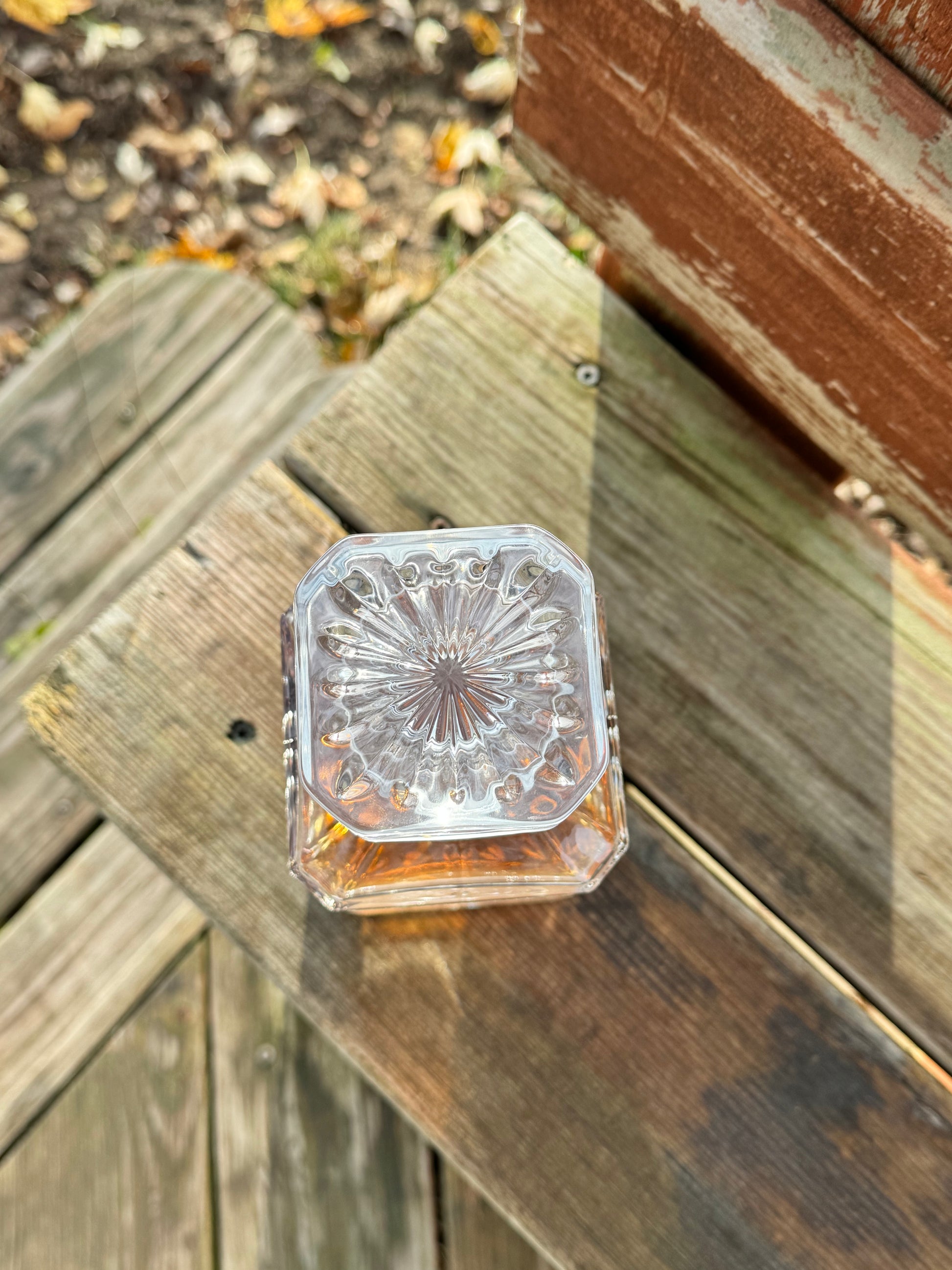 Top view of a square decanter showing the sunburst base pattern