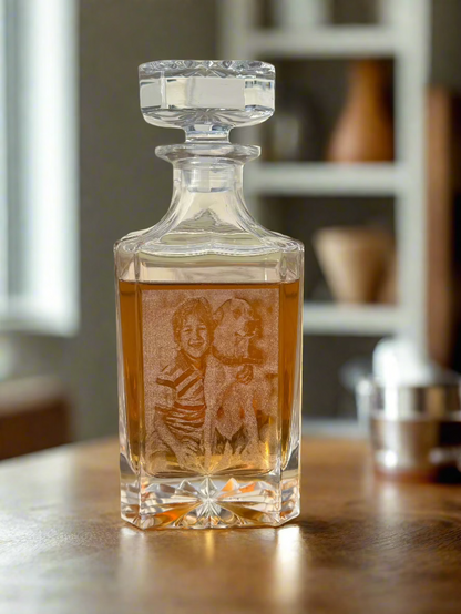 Engraved glass decanter filled with whiskey on a wood counter