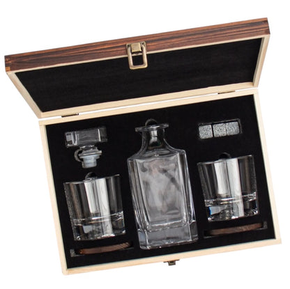 Glass decanter and glasses in an open wood box