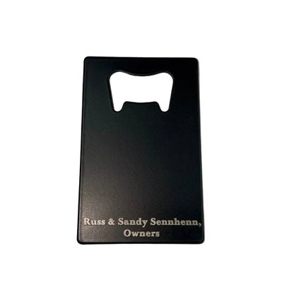 Back of an engraved bottle opener with owner names, showing double-sided engraving