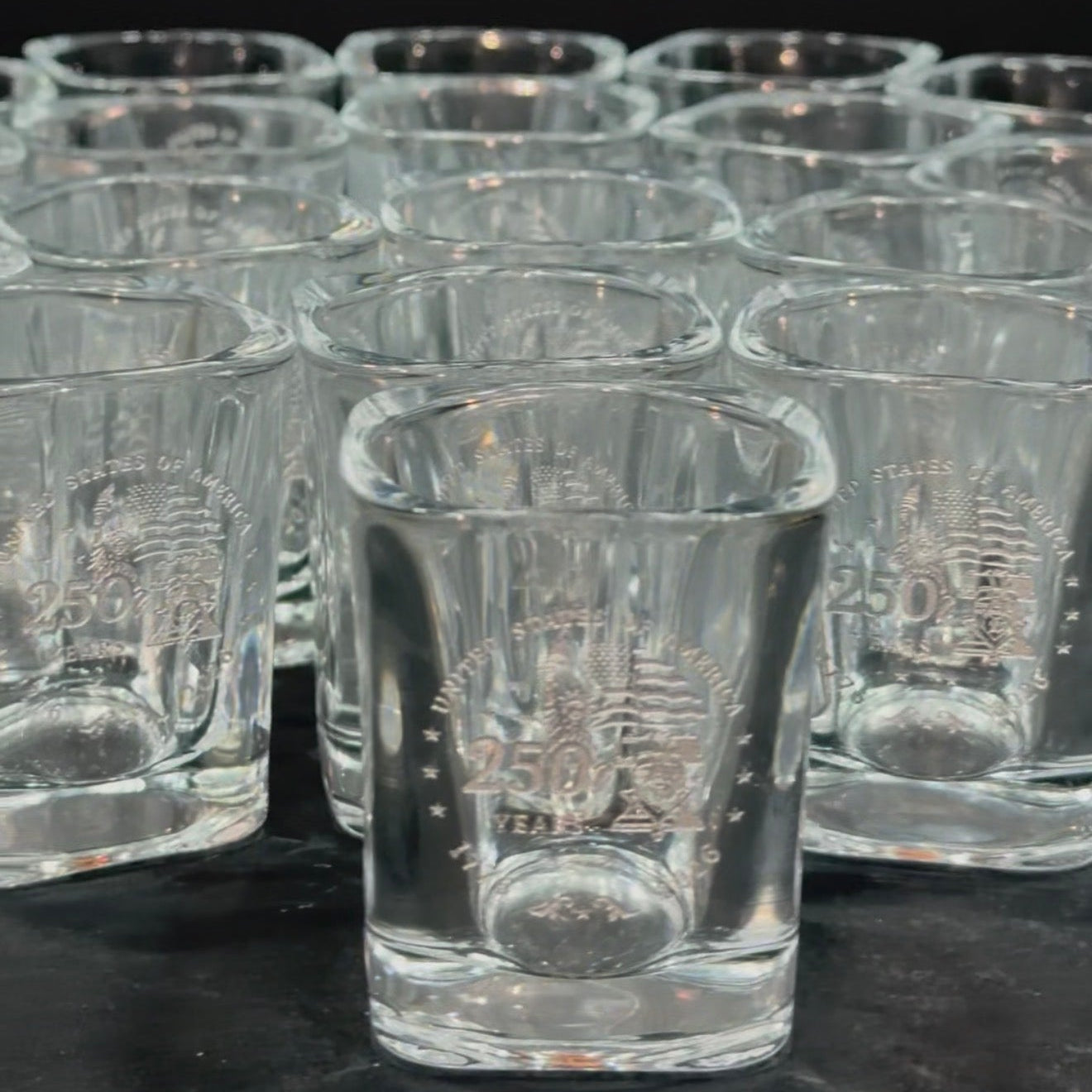 Group of engraved shot glasses with matching designs