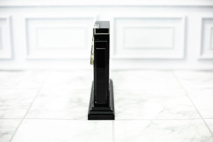Side profile of an optical crystal clock award showing the black crystal base