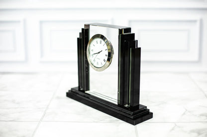 Engraved crystal clock award angled on a marble surface