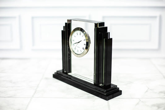 Engraved crystal clock award angled on a marble surface